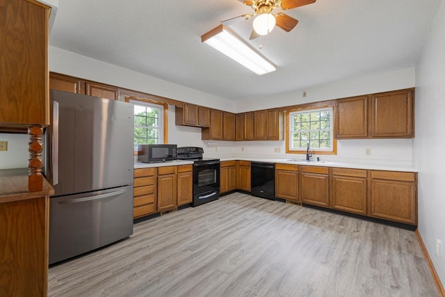 51343 20th Ave, Kenyon Twp, MN 55946 - kitchen featuring black appliances, brown cabinets, light wood-style floors, and a ceiling fan