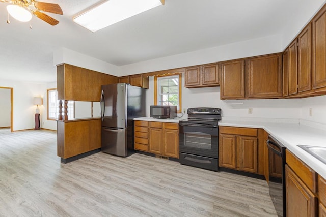 51343 20th Ave, Kenyon Twp, MN 55946 - kitchen with black appliances, brown cabinets, and light countertops