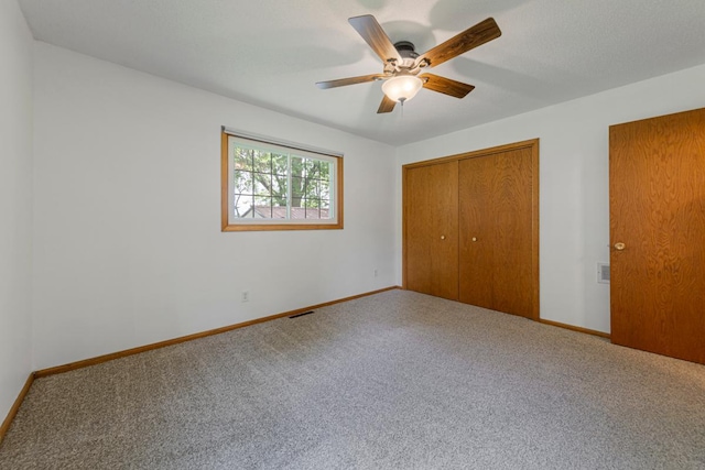 51343 20th Ave, Kenyon Twp, MN 55946 - unfurnished bedroom featuring carpet flooring, a closet, and a ceiling fan