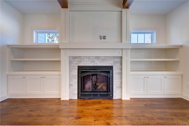 TBB403 College St, Northfield, MN 55057 - unfurnished living room featuring dark wood-type flooring and a fireplace
