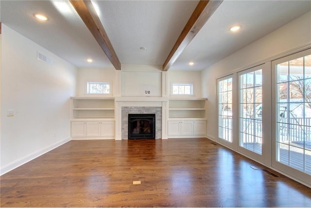 TBB403 College St, Northfield, MN 55057 - unfurnished living room featuring beam ceiling, dark wood finished floors, baseboards, a fireplace, and recessed lighting