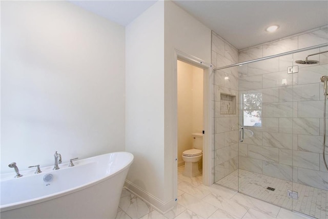 TBB403 College St, Northfield, MN 55057 - full bath with marble look tile flooring, a freestanding bath, a shower stall, toilet, and baseboards