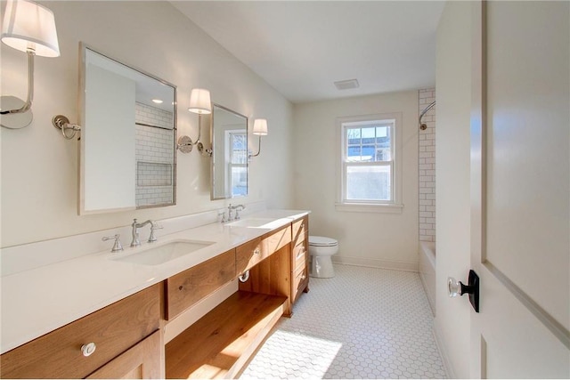TBB403 College St, Northfield, MN 55057 - bathroom with double vanity, toilet, bathing tub / shower combination, and baseboards