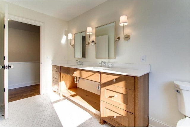 TBB403 College St, Northfield, MN 55057 - bathroom with double vanity, toilet, tile patterned floors, and baseboards
