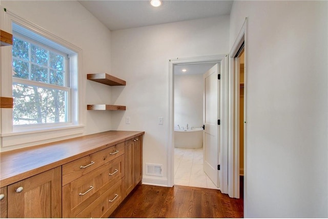 TBB403 College St, Northfield, MN 55057 - corridor featuring dark wood finished floors, baseboards, and recessed lighting