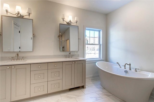 TBB403 College St, Northfield, MN 55057 - full bath featuring double vanity, a freestanding tub, and marble finish floors