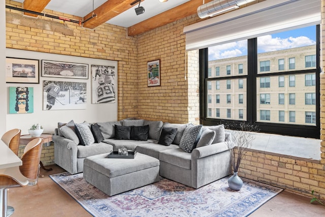 406 Wacouta St Unit 601, Saint Paul, MN 55101 - living room with brick wall, finished concrete flooring, and beam ceiling