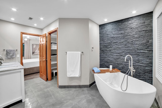 11260 Hidden Oaks Ct N, Champlin, MN 55316 - bathroom with a soaking tub, vanity, recessed lighting, and a walk in closet