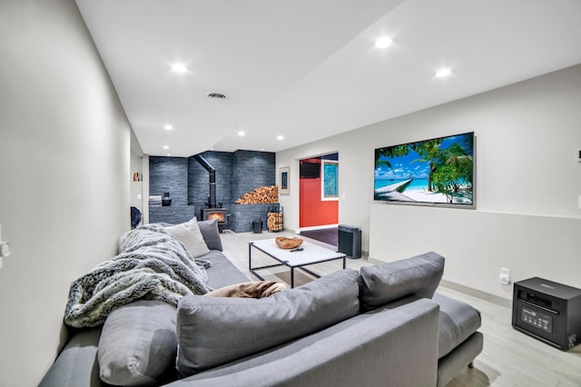 11260 Hidden Oaks Ct N, Champlin, MN 55316 - home theater room featuring a wood stove, recessed lighting, baseboards, and light wood-style flooring