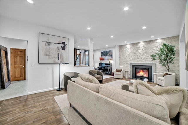 11260 Hidden Oaks Ct N, Champlin, MN 55316 - living room featuring a glass covered fireplace, wood finished floors, recessed lighting, and baseboards