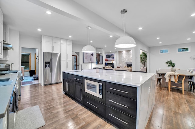 11260 Hidden Oaks Ct N, Champlin, MN 55316 - kitchen featuring stainless steel appliances, dark cabinets, light wood-type flooring, white cabinets, and recessed lighting