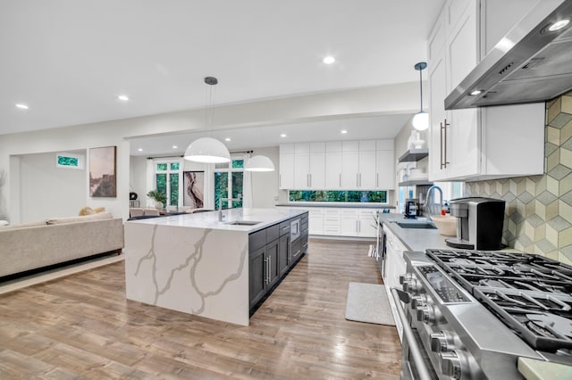 11260 Hidden Oaks Ct N, Champlin, MN 55316 - kitchen featuring range hood, white cabinetry, a sink, backsplash, and recessed lighting