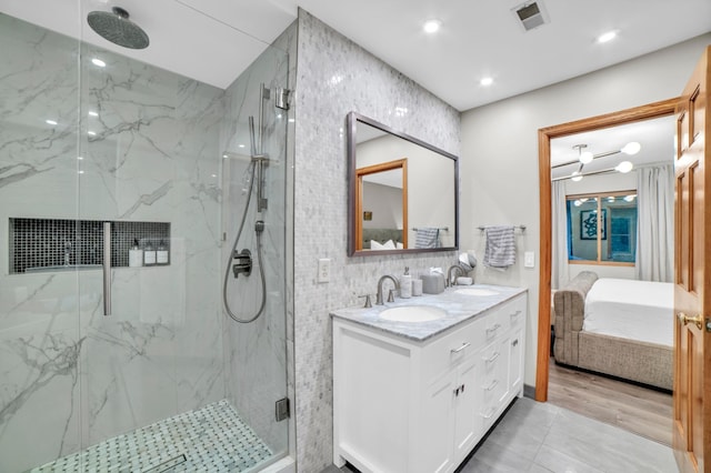 11260 Hidden Oaks Ct N, Champlin, MN 55316 - ensuite bathroom with a marble finish shower, double vanity, tile walls, and recessed lighting