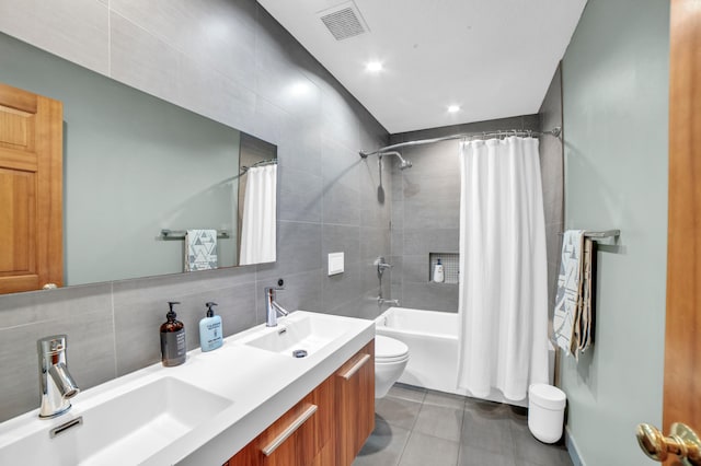 11260 Hidden Oaks Ct N, Champlin, MN 55316 - bathroom with toilet, shower / bathtub combination with curtain, tile walls, tile patterned flooring, and double vanity