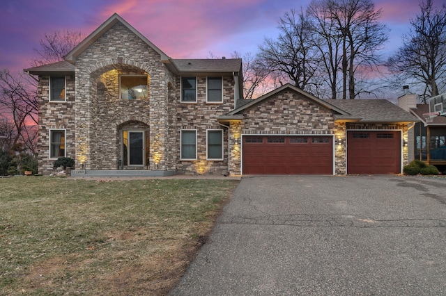 11260 Hidden Oaks Ct N, Champlin, MN 55316 - traditional-style home featuring an attached garage, stone siding, driveway, a front lawn, and roof with shingles