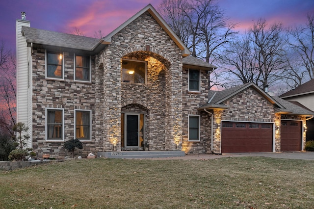 11260 Hidden Oaks Ct N, Champlin, MN 55316 - view of front of property with stone siding, an attached garage, a front yard, a chimney, and driveway