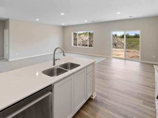 15981 Finale Ave N, Hugo, MN 55038 - kitchen with open floor plan, stainless steel dishwasher, a sink, light countertops, and white cabinetry