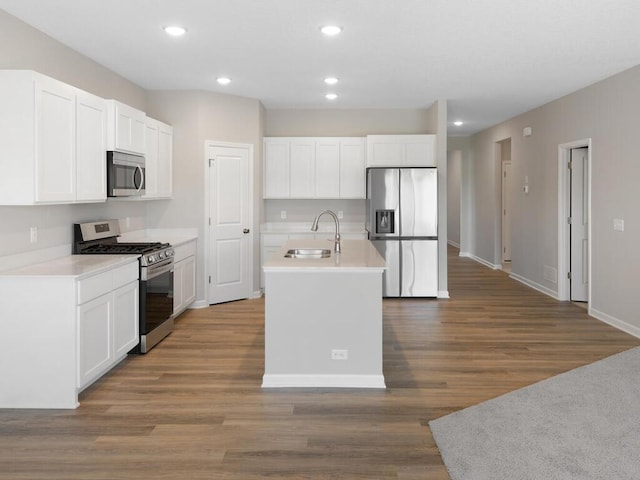 15981 Finale Ave N, Hugo, MN 55038 - kitchen with stainless steel appliances, a sink, white cabinets, light countertops, and recessed lighting