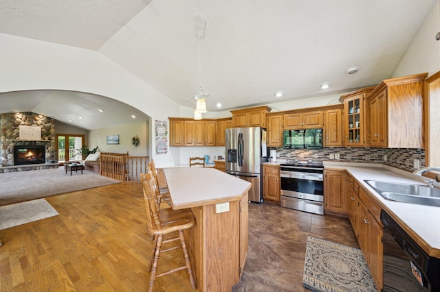 N1931 110th St, Union Twp, WI 54761 - kitchen with black appliances, a sink, lofted ceiling, light countertops, and a center island