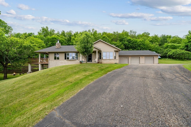 N1931 110th St, Union Twp, WI 54761 - ranch-style home featuring a front lawn, a chimney, and asphalt driveway