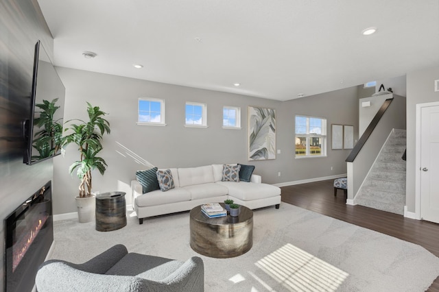14413 Allerton Way, Rosemount, MN 55068 - living room featuring stairs, wood finished floors, recessed lighting, baseboards, and a glass covered fireplace