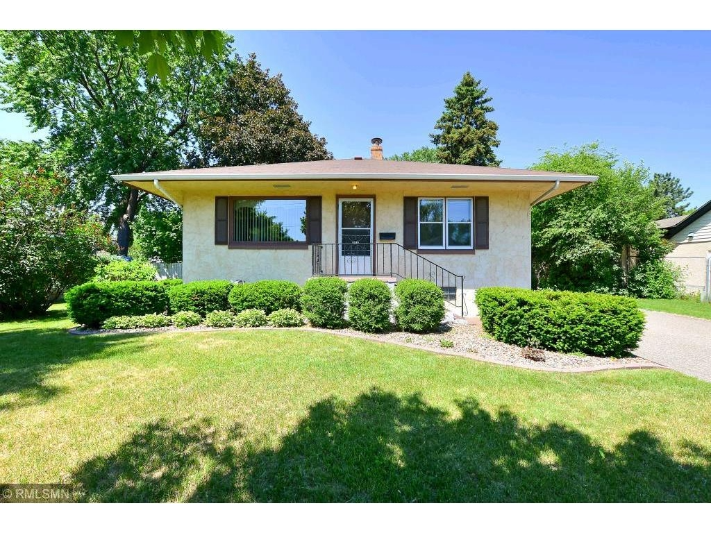 5749 Orchard Ave N, Crystal, MN 55429 - view of front facade with a front yard, stucco siding, and a chimney
