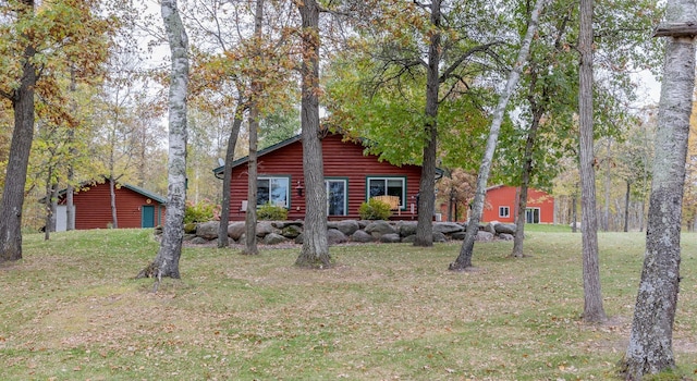 1087 Horseshoe Dr NW, Backus, MN 56435 - view of front facade with log veneer siding and a front lawn