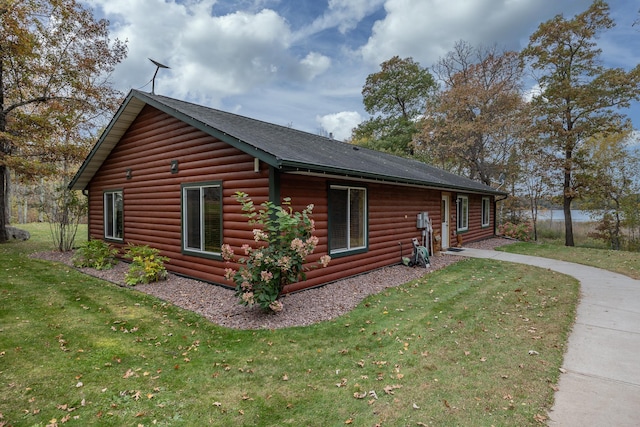 1087 Horseshoe Dr NW, Backus, MN 56435 - view of home's exterior featuring a lawn, faux log siding, and a shingled roof