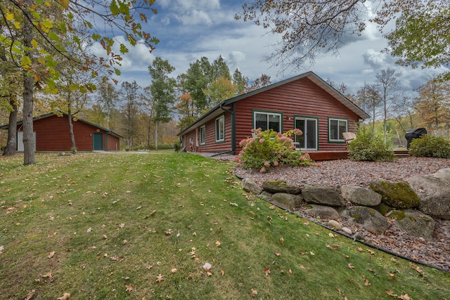 1087 Horseshoe Dr NW, Backus, MN 56435 - back of property with a yard, faux log siding, and a wooden deck