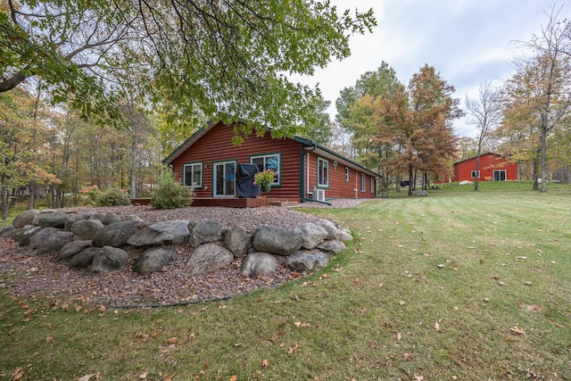 1087 Horseshoe Dr NW, Backus, MN 56435 - view of side of home featuring a lawn and faux log siding