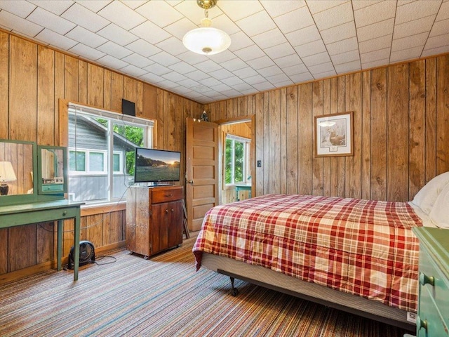 30202 Circle Dr, Breezy Point, MN 56472 - bedroom featuring wooden walls and light colored carpet