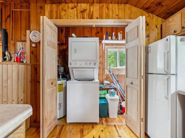 30202 Circle Dr, Breezy Point, MN 56472 - laundry area with stacked washing machine and dryer, wooden walls, light wood-style flooring, water heater, and wood ceiling