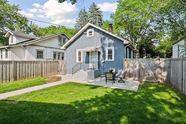 4636 Clinton Ave, Minneapolis, MN 55419 - rear view of house with a gate, stucco siding, a chimney, and a patio