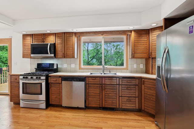 11600 Oberlin Rd, Minnetonka, MN 55305 - kitchen featuring stainless steel appliances, a sink, brown cabinets, healthy amount of natural light, and recessed lighting