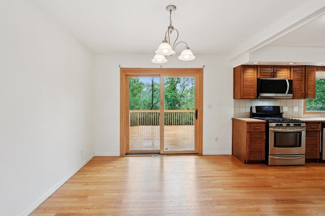 11600 Oberlin Rd, Minnetonka, MN 55305 - kitchen with stainless steel appliances, a chandelier, light countertops, and light wood-style floors