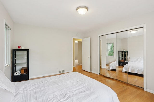 11600 Oberlin Rd, Minnetonka, MN 55305 - bedroom with wood finished floors, a closet, and baseboards