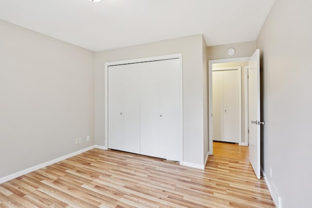 11600 Oberlin Rd, Minnetonka, MN 55305 - unfurnished bedroom with light wood-style flooring, a closet, and baseboards
