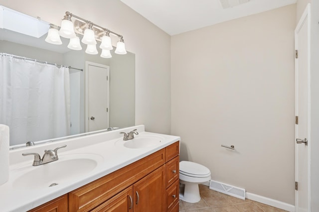 11600 Oberlin Rd, Minnetonka, MN 55305 - bathroom with toilet, tile patterned flooring, double vanity, and baseboards