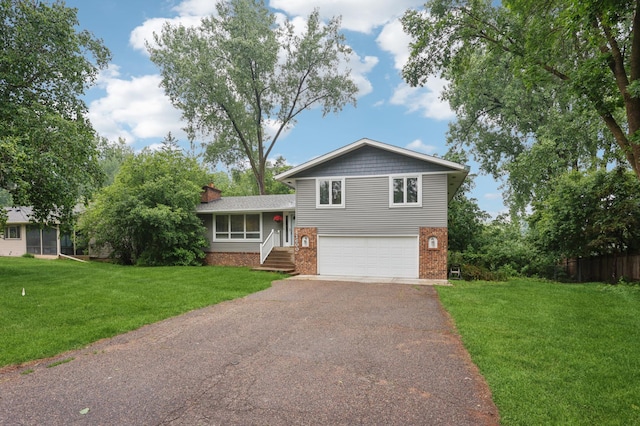 11600 Oberlin Rd, Minnetonka, MN 55305 - tri-level home featuring driveway, brick siding, and an attached garage