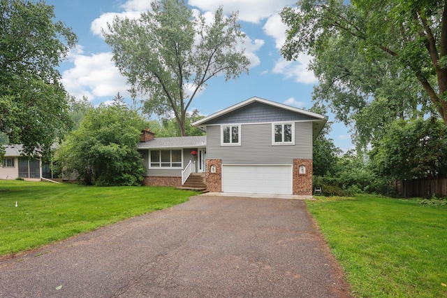 11600 Oberlin Rd, Minnetonka, MN 55305 - tri-level home featuring brick siding, asphalt driveway, a garage, and a chimney