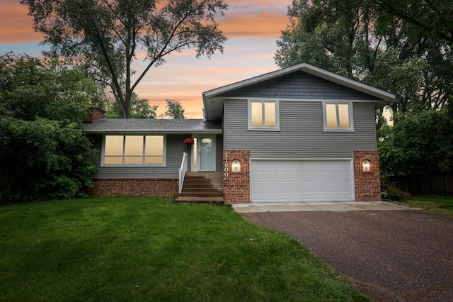 11600 Oberlin Rd, Minnetonka, MN 55305 - tri-level home with asphalt driveway, a garage, brick siding, a front lawn, and a chimney