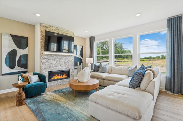 9874 49th St NE, Saint Michael, MN 55376 - living room with a stone fireplace, wood finished floors, baseboards, and recessed lighting