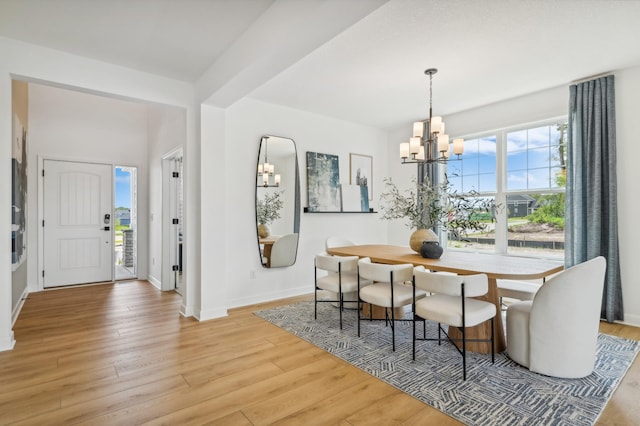 9874 49th St NE, Saint Michael, MN 55376 - dining space featuring a chandelier, light wood finished floors, and baseboards
