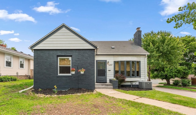 5257 27th Ave S, Minneapolis, MN 55417 - view of front facade with a front lawn, a chimney, central air condition unit, and brick siding