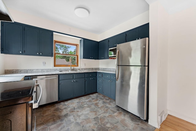 5257 27th Ave S, Minneapolis, MN 55417 - kitchen featuring appliances with stainless steel finishes, a sink, light countertops, and blue cabinets