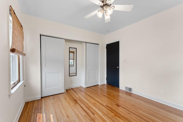 5257 27th Ave S, Minneapolis, MN 55417 - unfurnished bedroom featuring baseboards, light wood-style floors, multiple windows, and a closet