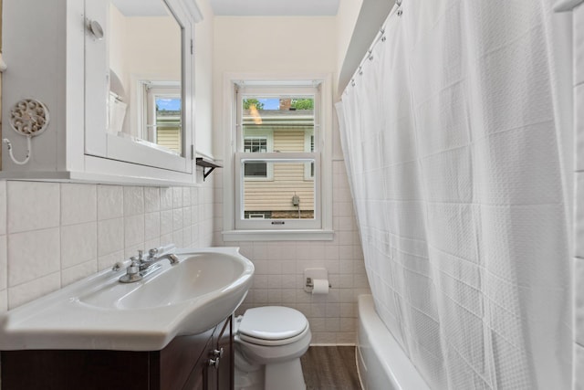 5257 27th Ave S, Minneapolis, MN 55417 - full bathroom featuring tile walls, vanity, toilet, and shower / bath combination with curtain