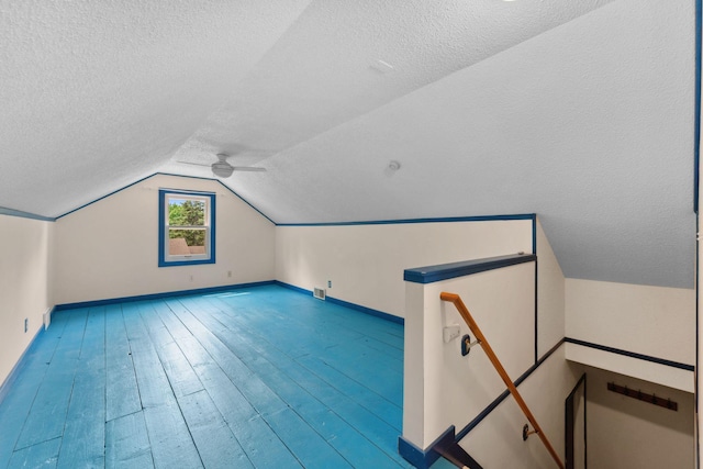 5257 27th Ave S, Minneapolis, MN 55417 - additional living space with a textured ceiling, lofted ceiling, baseboards, and wood finished floors