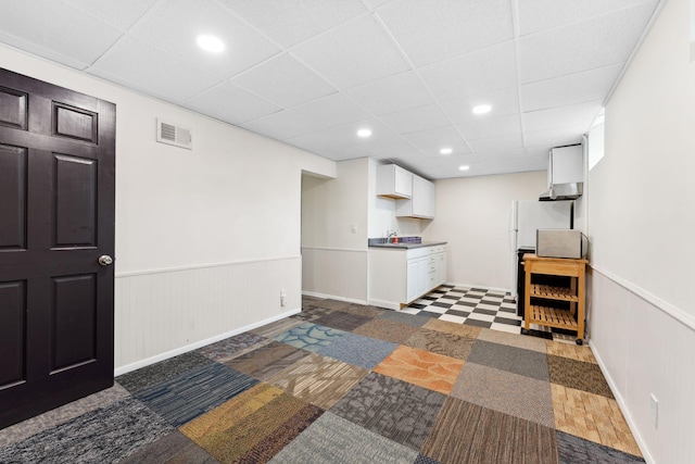 5257 27th Ave S, Minneapolis, MN 55417 - finished basement with a wainscoted wall, a paneled ceiling, recessed lighting, freestanding refrigerator, and tile patterned floors