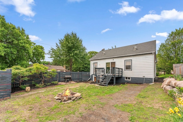 5257 27th Ave S, Minneapolis, MN 55417 - back of property with an outdoor fire pit, a fenced backyard, and a deck